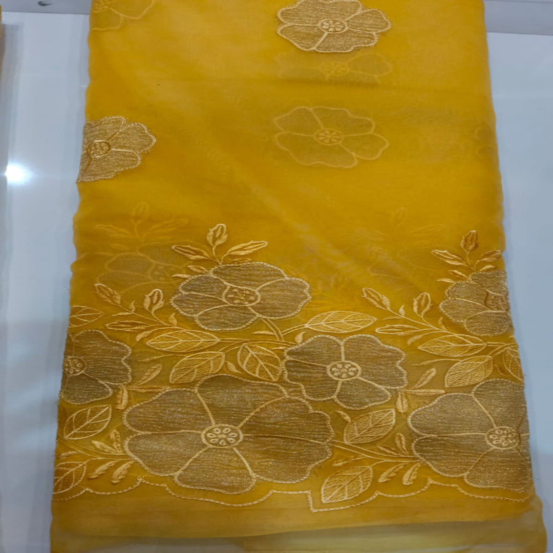 Yellow organza fabric with floral patterns on a white background
